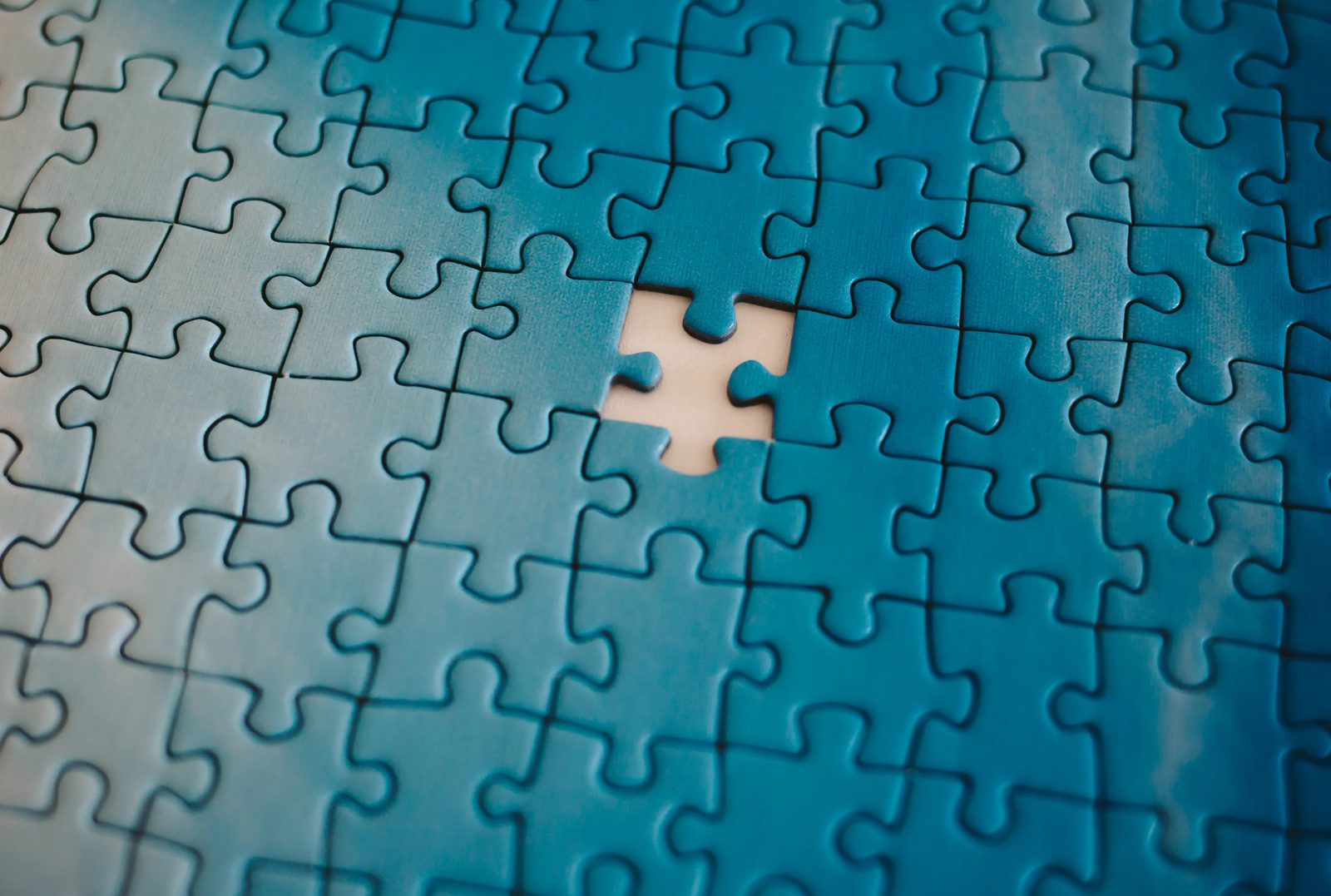 Blue jigsaw puzzle with one piece missing